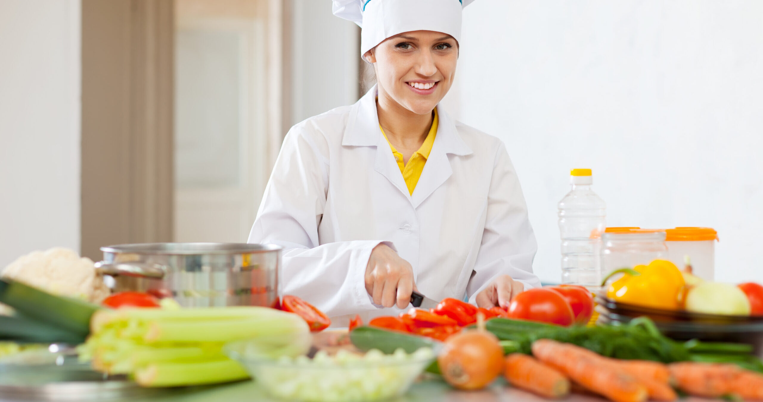 Happy,Beautiful,Cook,In,Toque,Works,With,Tomato,And,Other