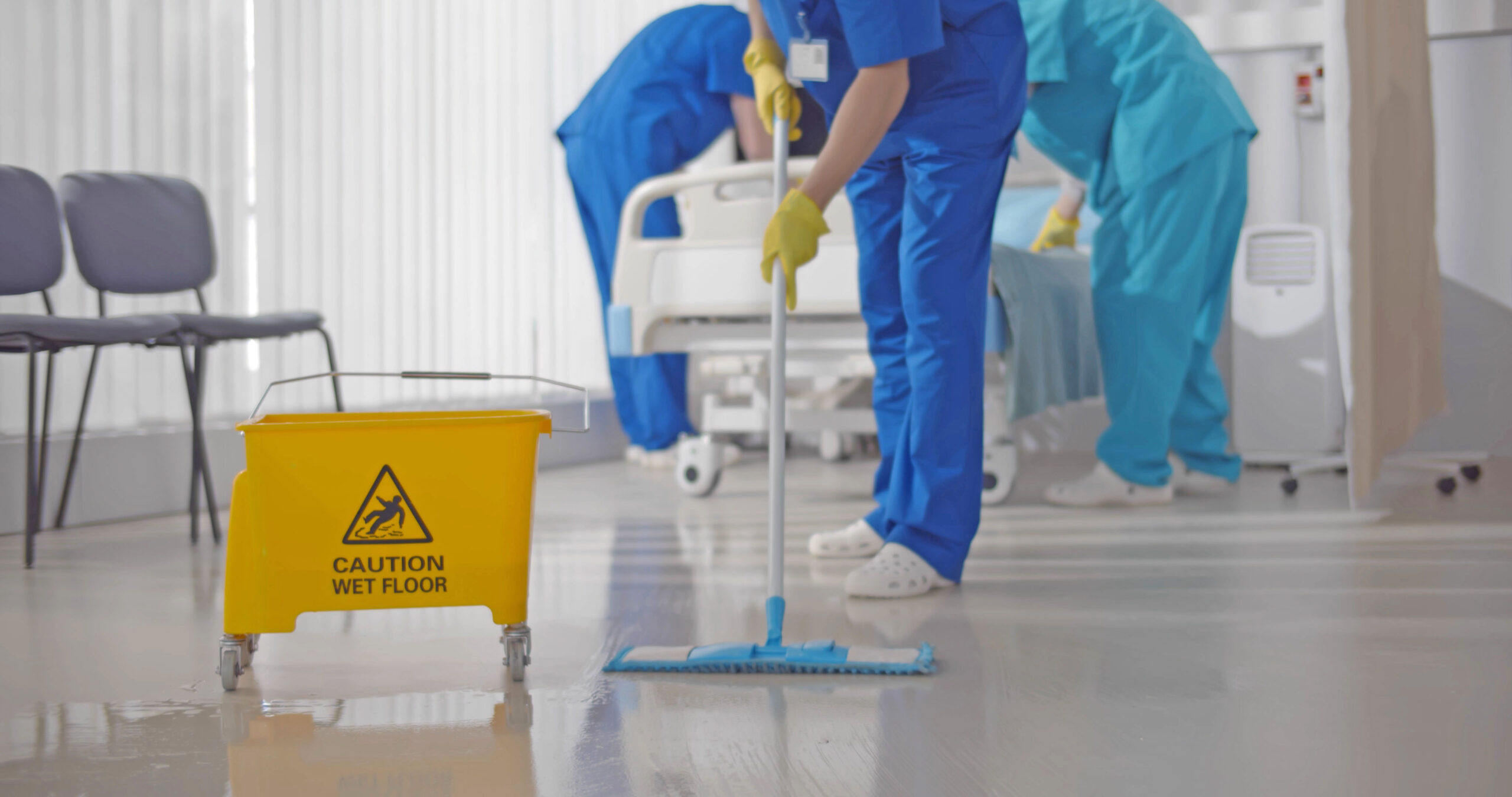 Nurses,Mopping,Floor,And,Making,Bed,In,Empty,Hospital,Ward.